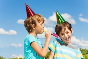 Kid blowing on birthday toy